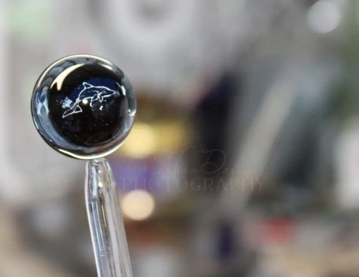 Dark dolphin design being made in borosilicate glass by Jose Valdes