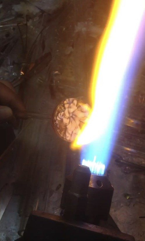A borosilicate glass marble being worked in the flame by Jose Valdes