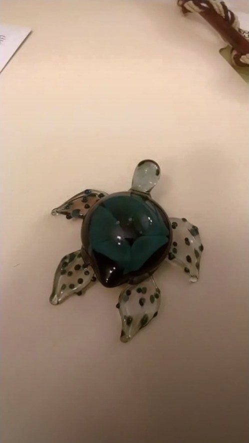 Dark borosilicate glass turtle with a teal flower shell by Jose Valdes